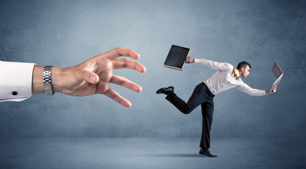 Businessman running from hand