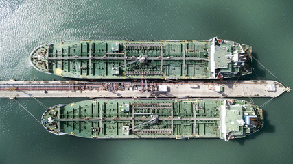 Aerial shot of two tanker ships anchored at the oil terminal at port