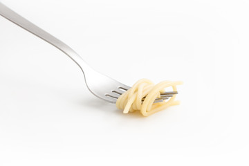 Plain cooked spaghetti pasta on fork, on white background.