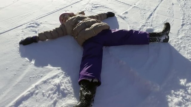 A child makes a snow angel