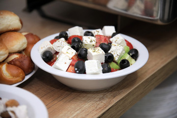 Greek salad with tomatoes, black olives, onion