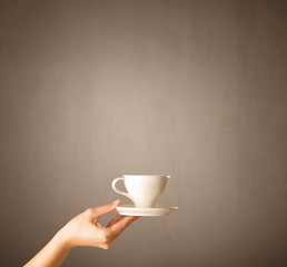Female hand holding coffee cup
