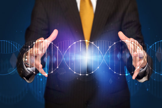 Businessman holding DNA - Powered by Adobe