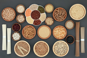 Healthy dried macrobiotic food with soba and udon noodles, pulses, cereals, whole wheat pasta, seeds and cereals, high in protein, omega 3,  antioxidants  and vitamins on rustic background,  