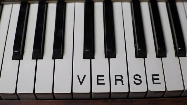 VERSE written on white piano keys