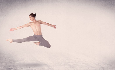 Fototapeta premium Modern ballet dancer performing art jump with empty background