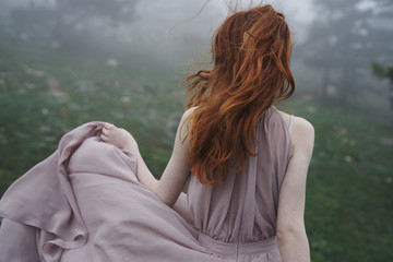 Rear view of woman in misty field