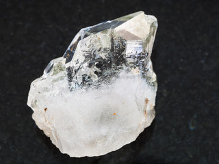 rough rock-crystal of quartz gemstone on dark