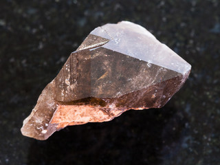 crystal of smoky quartz gemstone on dark