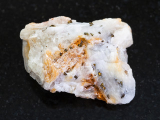 native gold in rough quartz stone on dark