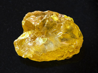 raw crystal of sulphur stone on dark background