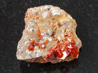 raw crystal of Vanadinite gemstone on dark