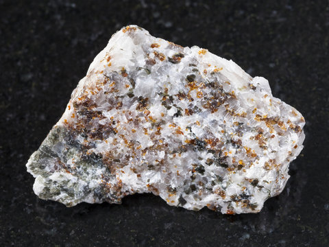 chondrodite and diopside in calcite stone on dark