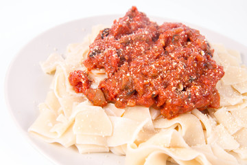 Pappardelle with bolognese sauce on a white background