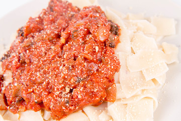Pappardelle with bolognese sauce on a white background