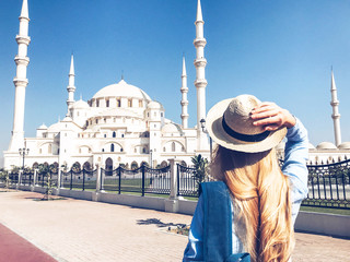 Hipster Traveler with backpack. Enjoying sun in the United Arab Emirates.
