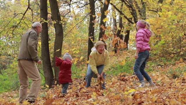 Grandparents and kids having fun in autumn park