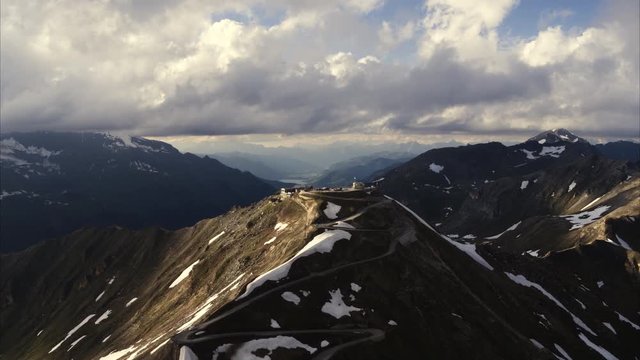 Wide aerial shot of cars parked on top of mountain pass / Grossglockner, Austria