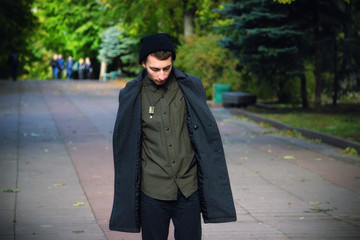 Fototapeta na wymiar Portrait of young stylish man with bag in the street