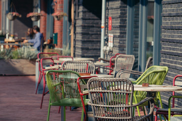 An outdoor cafe with colorful chairs in Amsterdam, Holland, Europe.