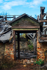 An old abandoned ruined wooden building. Broken doorway. Scenery for film about war