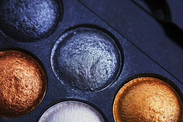 Glitter eye shadows palette on black background