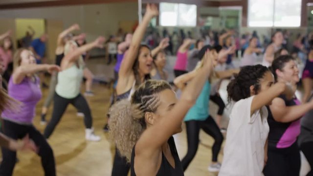 Medium high to low angle shot of people dancing in exercise class / Orem, Utah, United States