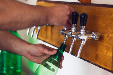 Man pouring wine into a plastic bottle