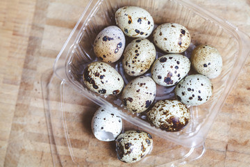 Quail eggs lie in a transparent box