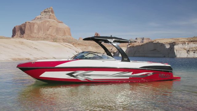 Wide shot of empty speedboat anchored in lake / Lake Powell, Utah, United States