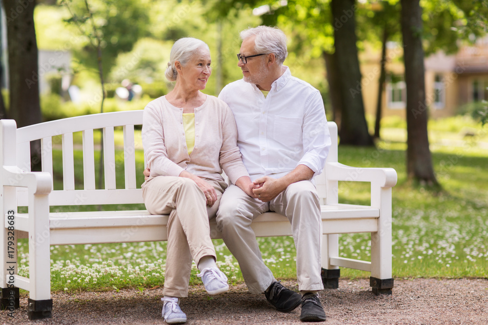 Canvas Prints happy senior couple sitting on bench at park