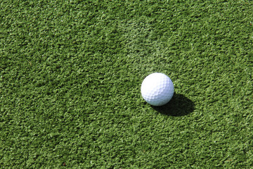 Close up of white golf ball on golf green