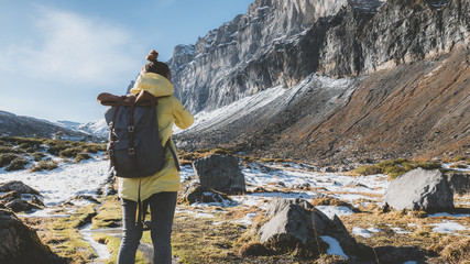 Obraz premium Attractive female hiking in high mountains, French Alps, mountain peaks covered with snow in the background