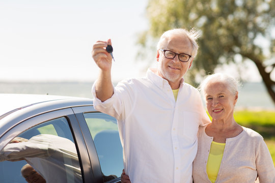 Happy Senior Couple With Car Key At Seaside