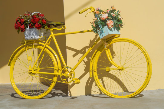 Colorful painted yellow bicycle decorated with flowers