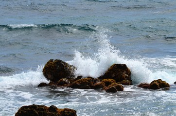 Waves crashing into the rocks on the shore