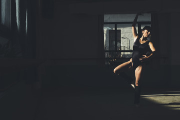 Fototapeta na wymiar Ballet dancer practicing indoors.