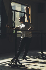 Ballet dancer practicing indoors.