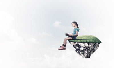 Concept of careless happy childhood with girl reading book