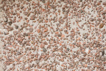 concrete wall is faced with rubble, rough style