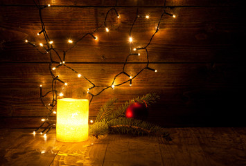 christmas decorations and lights on wooden background