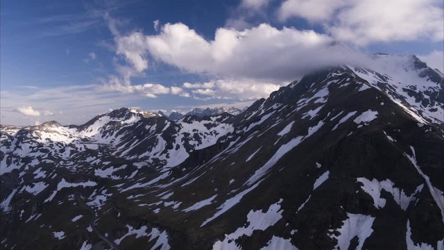Wide aerial panning shot of snow on mountain range / Grossglockner, Austria