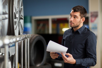 auto business owner and wheel rims at car service
