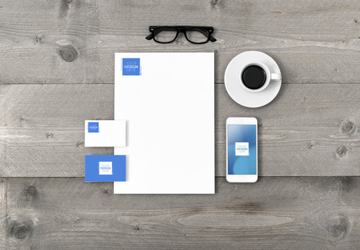 Stationery, Smartphone and Espresso on Wooden Table Mockup