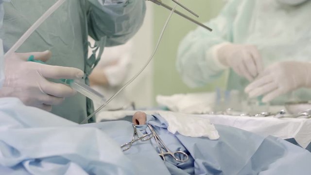 close-up. the hands of the neurosurgeon in a sterile clothes washes the nasal cavity vasoconstrictor solution