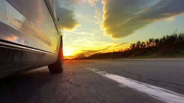 Driving Sunset sunrise point of view shot along empty highway, back view pov