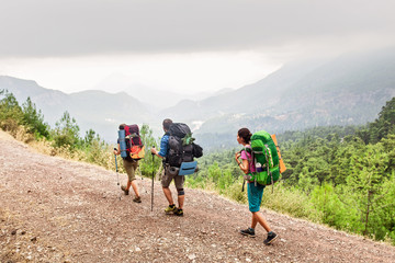 Fototapeta premium A group of three modern tourists backpackers travels in the summer along the Lycian Way in Turkey