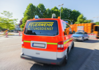 german emergency doctor car from fire department drives on a street.