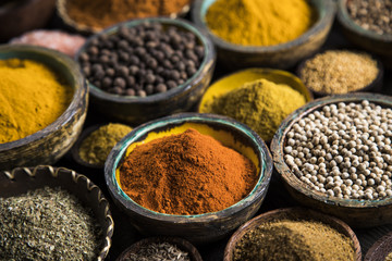 Variety of wooden, spices and herbs on kitchen table