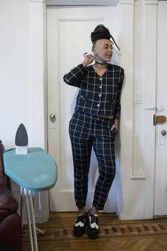 Smiling young woman standing at home